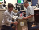 scc inturn student camila helping load frozen semen tank for shipping